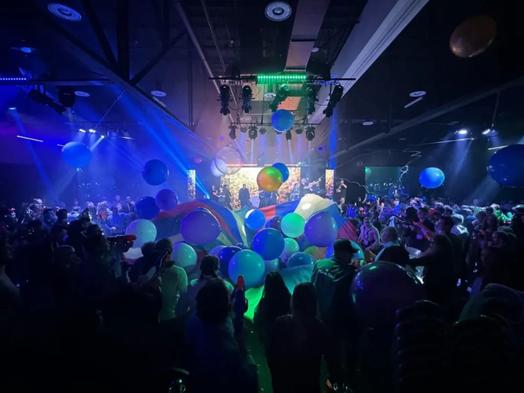 party in the ballroom with balloons falling from ceiling
