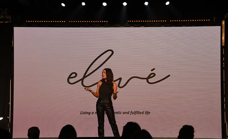 Woman presenting on stage at EXP