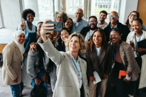 Smiling colleagues taking a selfie at a corporate event